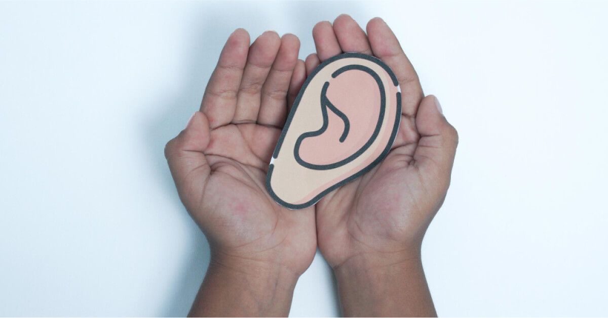 Hands holding image of ears